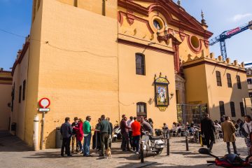 Patrons from Bar Bistec Gather in the plaza at Triana's Iglesia de Santa Ana