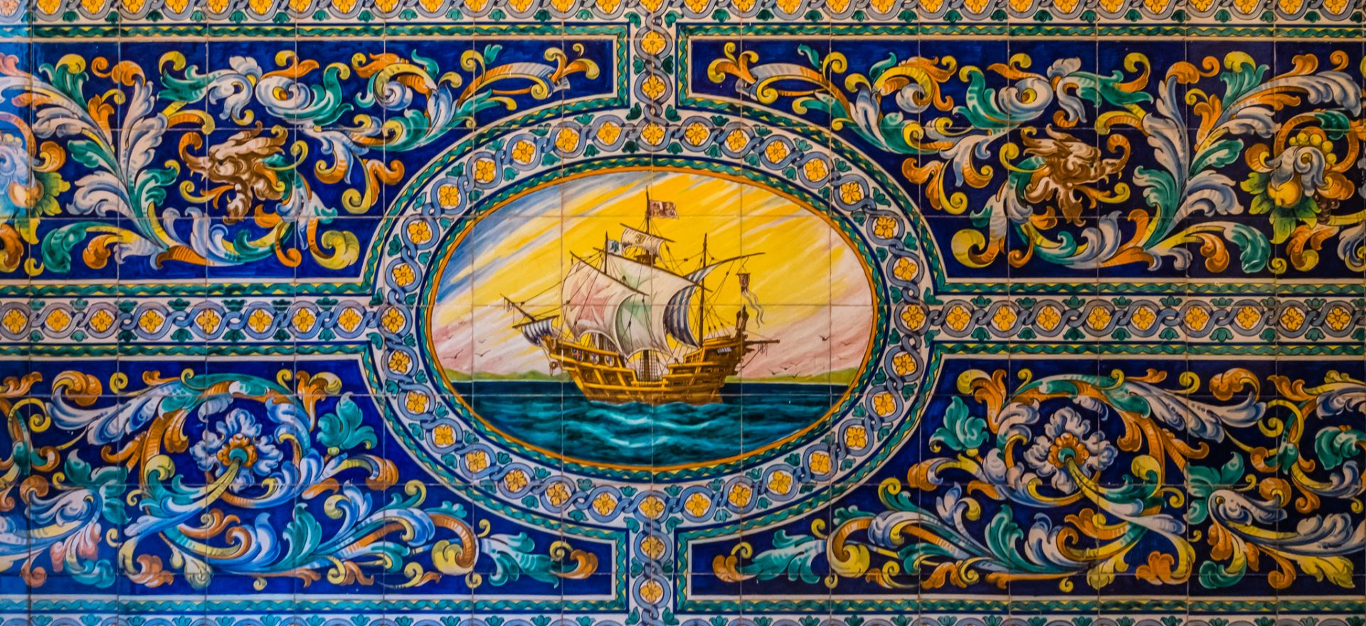 Tilework depicting a large sailing vessel with floral motif decoration around it