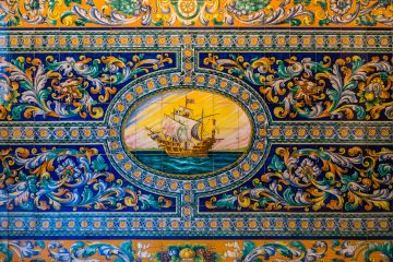 Tilework depicting a large sailing vessel with floral motif decoration around it